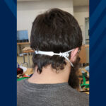 a man shows of a mask extender that keeps the straps off the ears